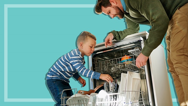 father and son loading dishwasher